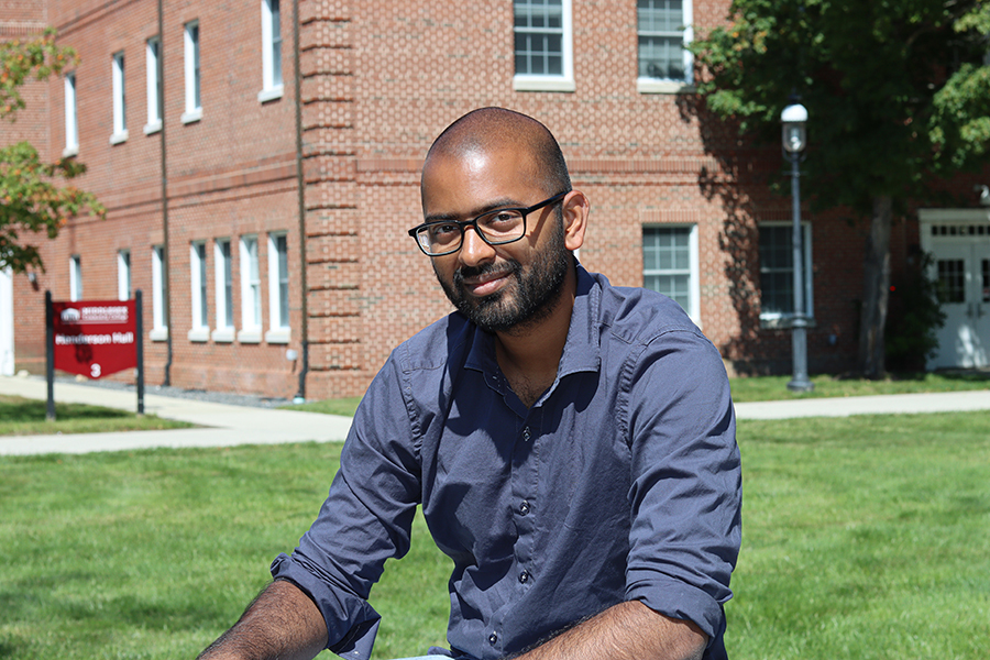 Irfan Margoob sitting in bedford quad and smiling at the camera